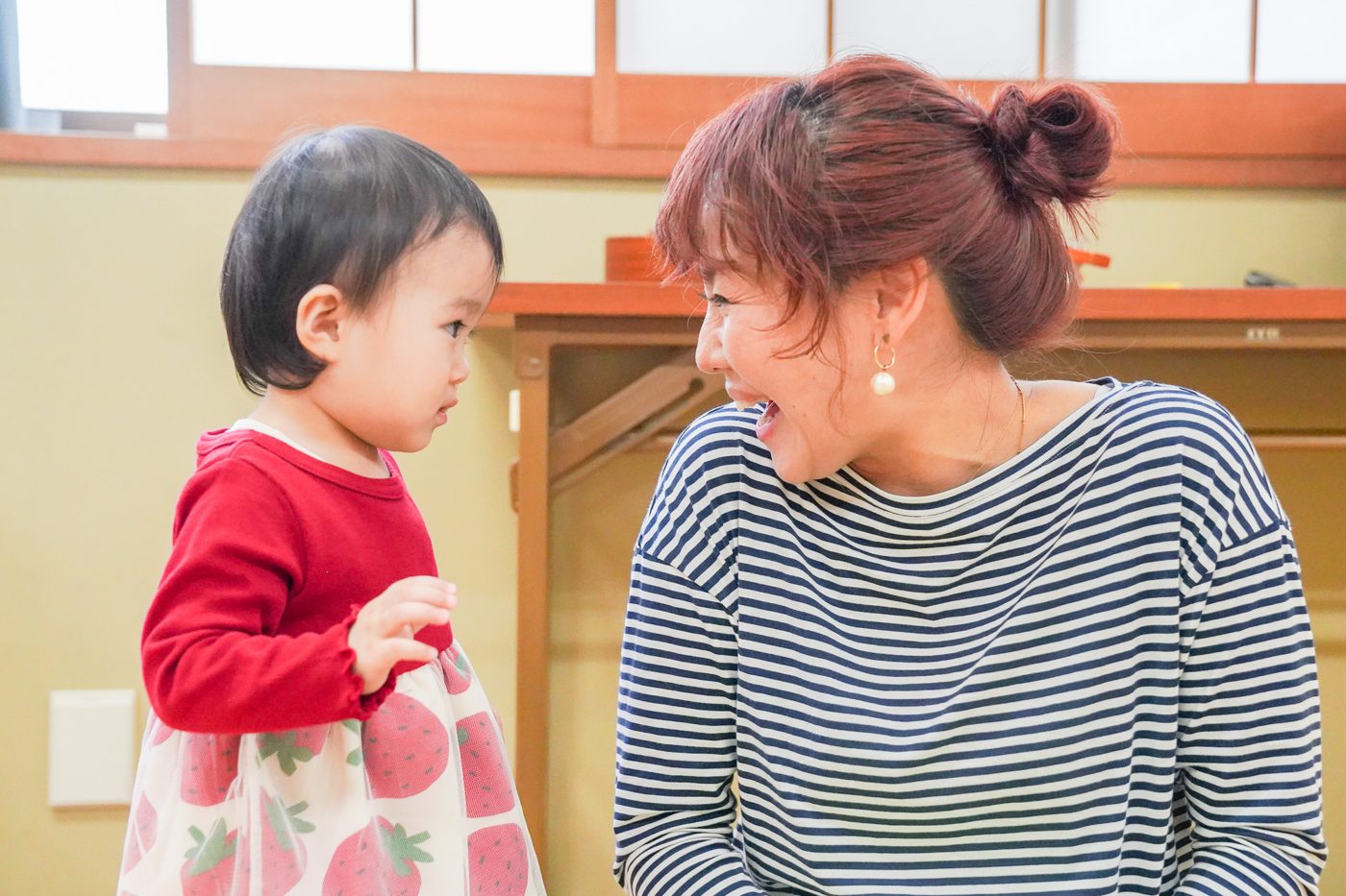 子どもと同じ目線で笑いかけるTOMOMI